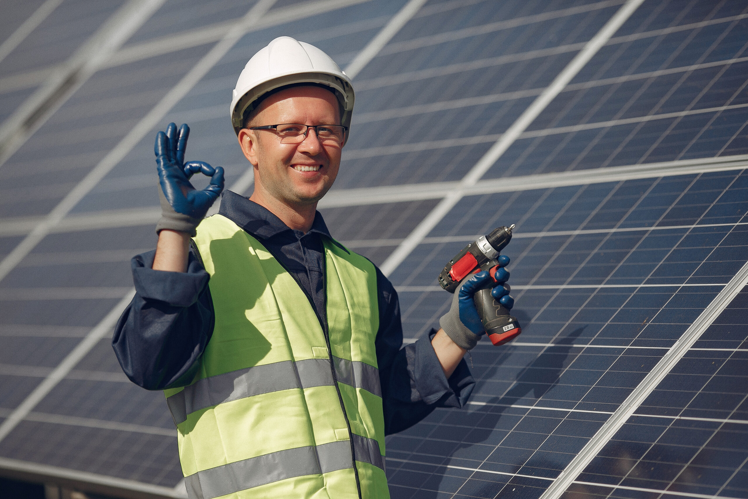 Engineer in a white helmet. Man near solar panel.