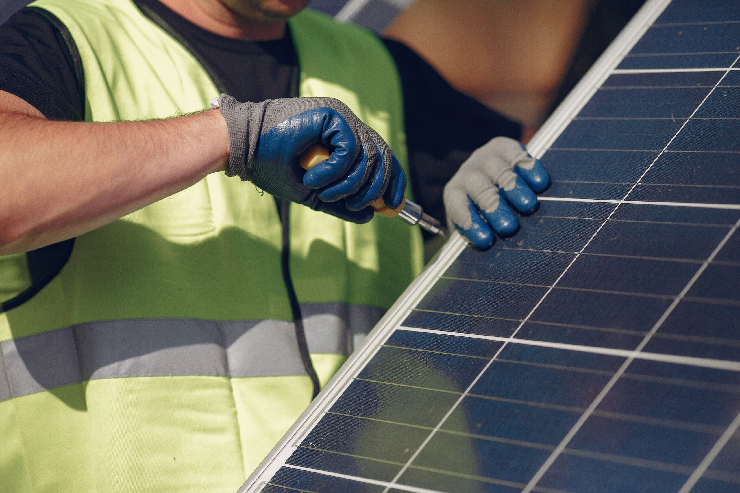 Engineer in a white helmet. Man near solar panel.